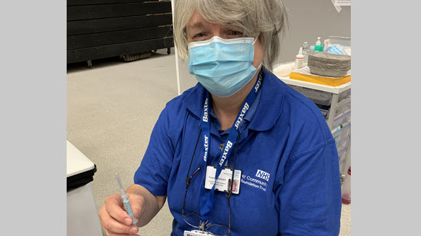 Baxter employee masked up who is volunteering at a COVID-19 vaccine clinic