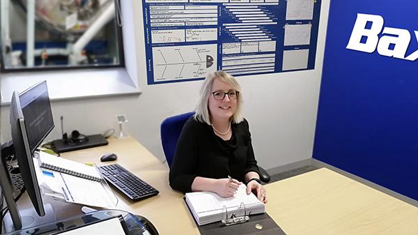 Image of Baxter plant manager posing in her office